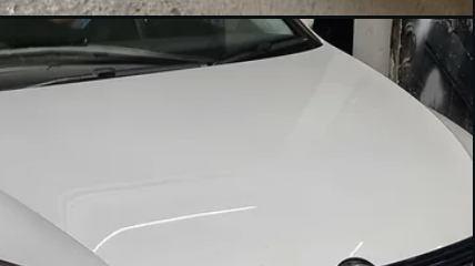 A freshly repaired car bonnet finished to a smooth, factory-clean panel